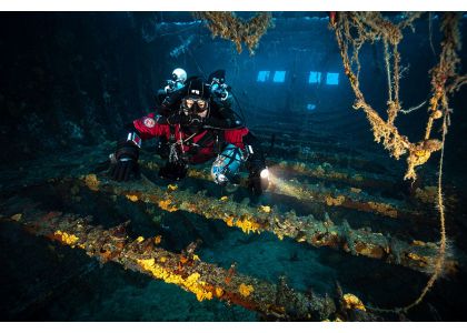 Why would a CCR diver attach an inflator hose to their deco gas bottles?